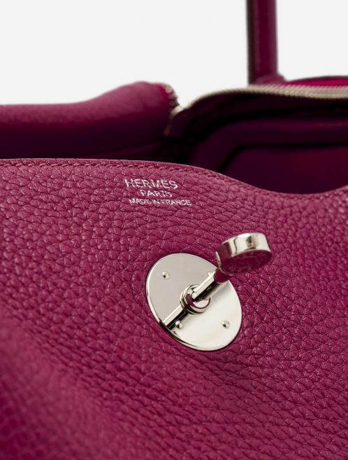 Hardware detail of a pre-loved Hermès Lindy 30 Taurillon Clemence Rubis on SACLÀB