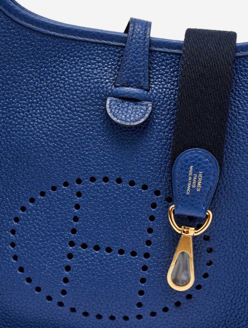 Perforated H on the frontside of a pre-loved Hermès Evelyne 16 Amazone Blue Sapphire / Blue Indigo on SACLÀB