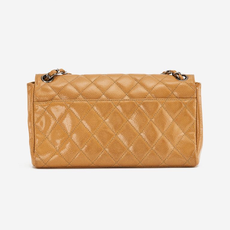 A pre-loved Chanel 2.55 Medium in Beige Caviar Patent Leather on SACLÀB