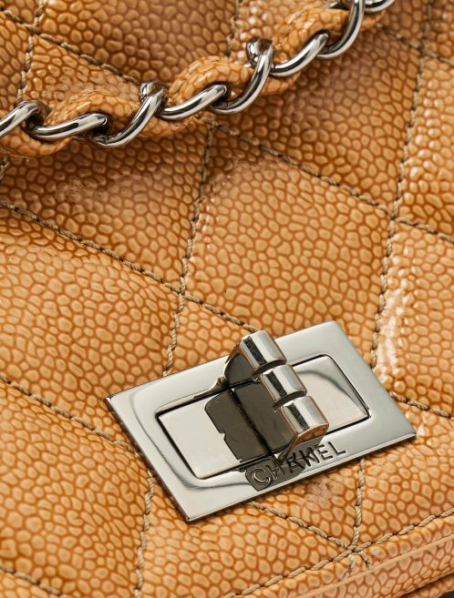 A pre-loved Chanel 2.55 Medium in Beige Caviar Patent Leather on SACLÀB