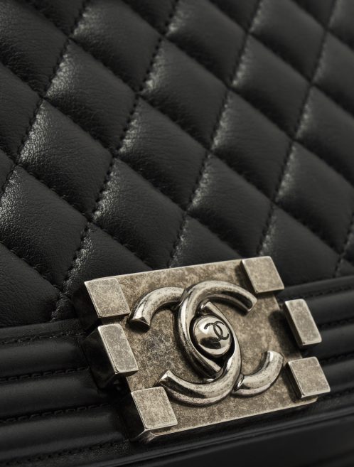 CC Logo Detail on a pre-loved Chanel Boy Medium Lambskin Black on SACLÀB