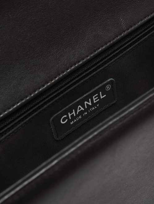 Logo Detail on a pre-loved Chanel Boy Medium Lambskin Black on SACLÀB