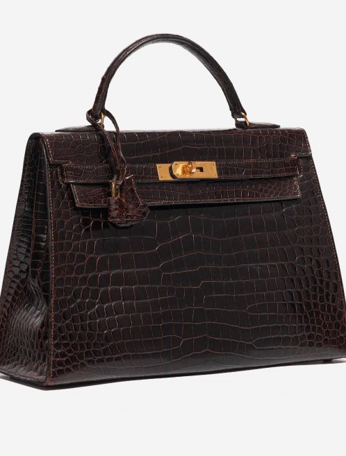 Pre-owned Hermès bag Kelly 32 Porosus Crocodile Dark Brown Brown Side Front | Sell your designer bag on Saclab.com