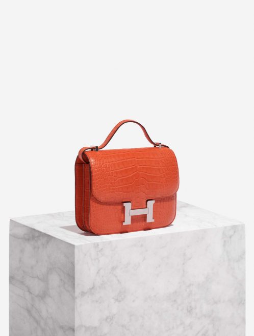 Pre-owned Hermès bag Constance 18 Matte Alligator Orange Poppy Orange Side Front | Sell your designer bag on Saclab.com