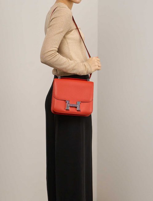 Hermès Constance 24 OrangePoppy on Model | Sell your designer bag on Saclab.com