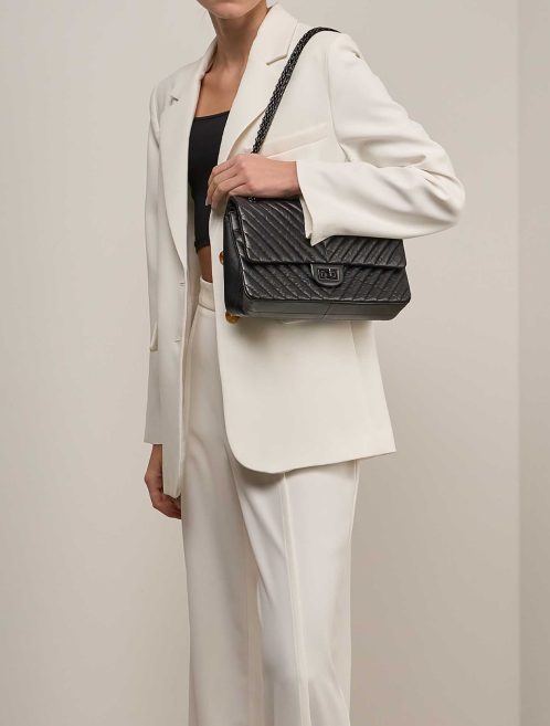 Chanel 2.55 Reissue 226 Aged Calf Black on Model | Sell your designer bag