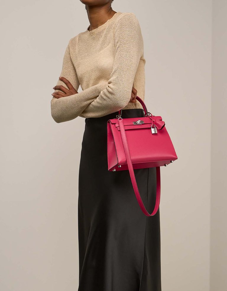 Hermès Kelly 25 Veau Madame Rose Extrême / Rouge Piment on Model | Sell your designer bag