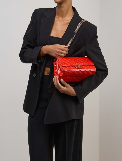 Chanel 2.55 Reissue 225 Patent Red on Model | Sell your designer bag