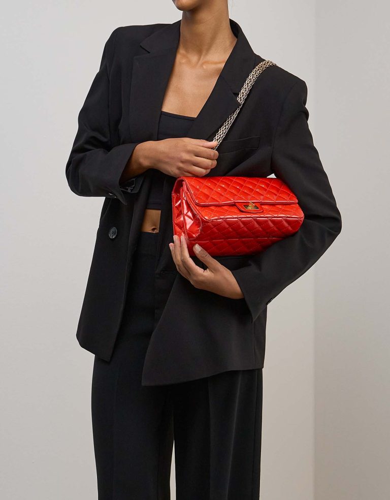 Chanel 2.55 Reissue 225 Patent Red on Model | Sell your designer bag