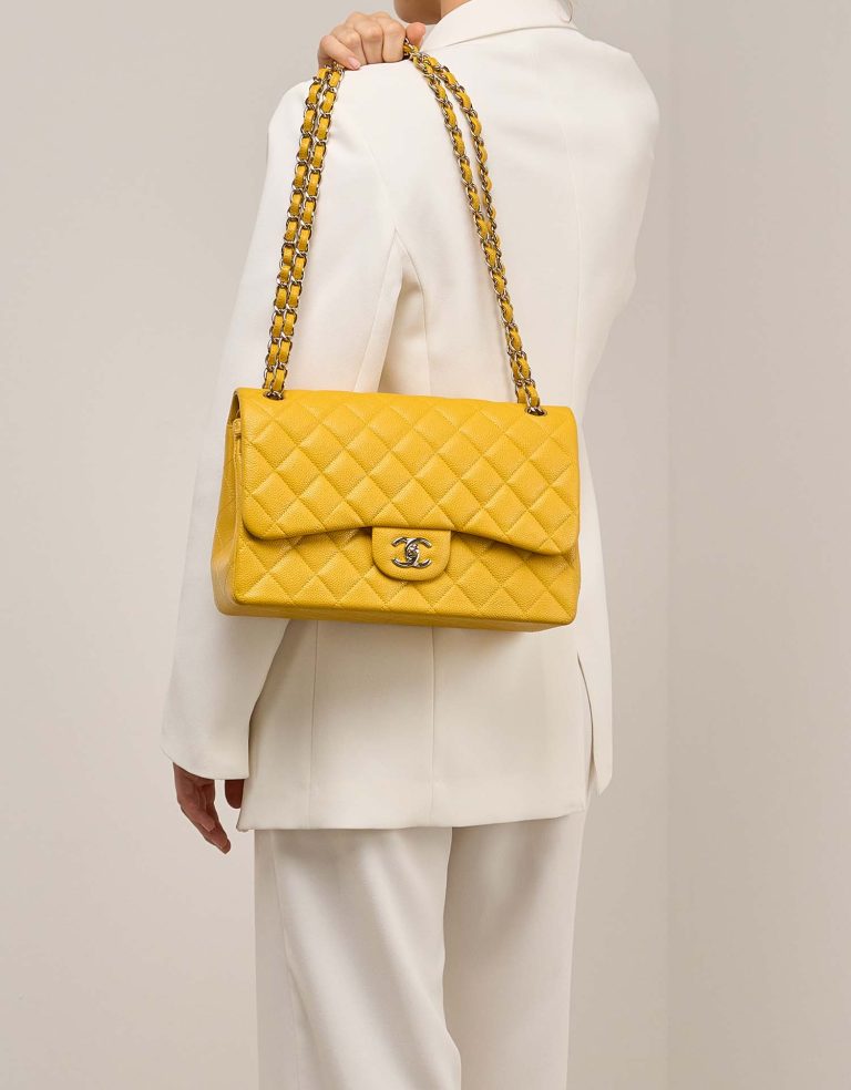 Chanel Timeless Jumbo Caviar Amber on Model | Sell your designer bag