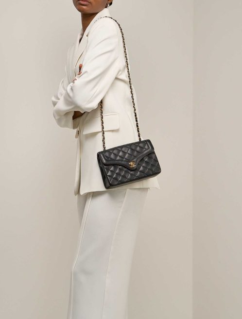 Chanel Timeless Flap Bag Small Lamb Black on Model | Sell your designer bag