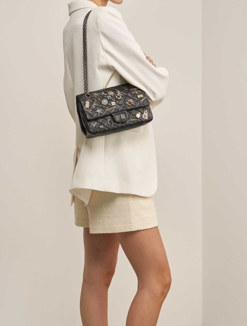 Chanel 2.55 Reissue Lucky Charms 225 Aged Calf Black on Model | Sell your designer bag