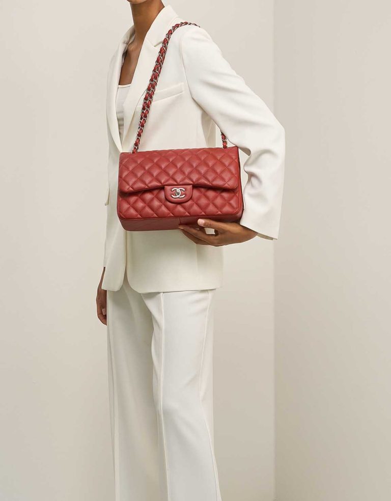 Chanel Timeless Jumbo Caviar Dark Red on Model | Sell your designer bag