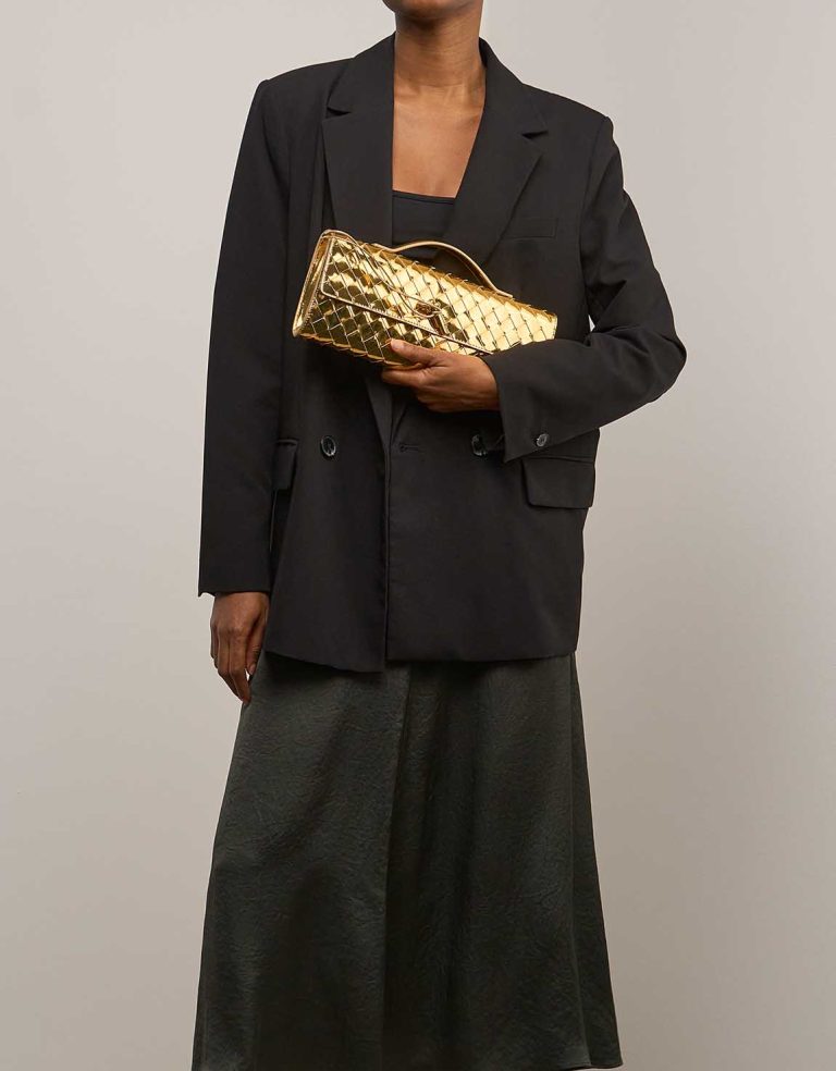 Bottega Veneta Andiamo Clutch Patent Metallic Gold on Model | Sell your designer bag