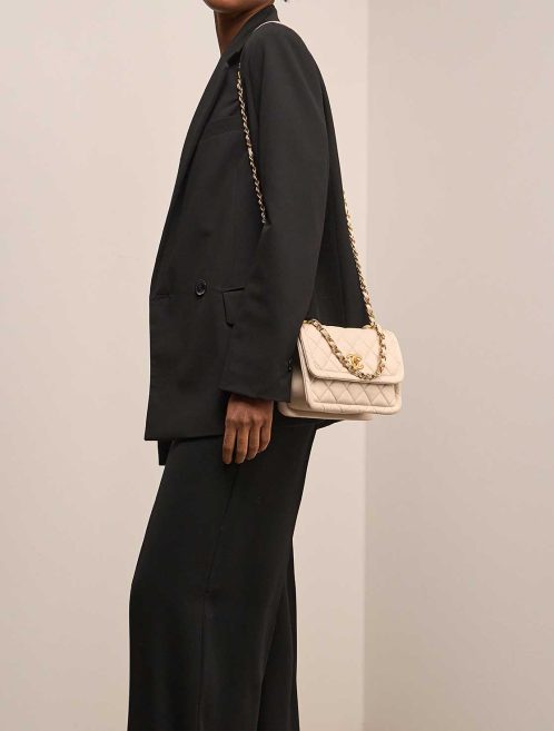 Chanel Timeless Flap Bag Small Lamb Off White on Model | Sell your designer bag
