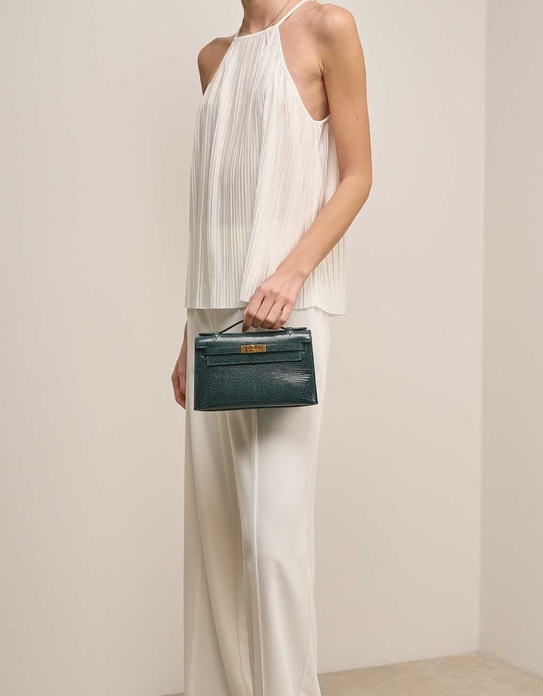 Hermès Kelly Pochette Niloticus Lizard Vert Cyprès on Model | Sell your designer bag