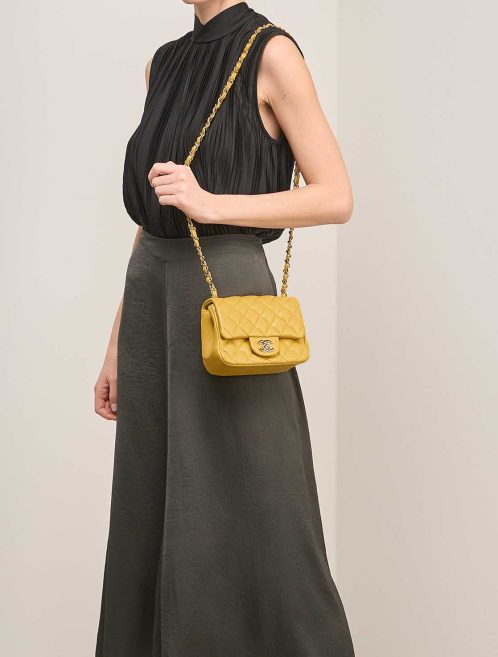 Chanel Timeless Mini Square Caviar Yellow on Model | Sell your designer bag