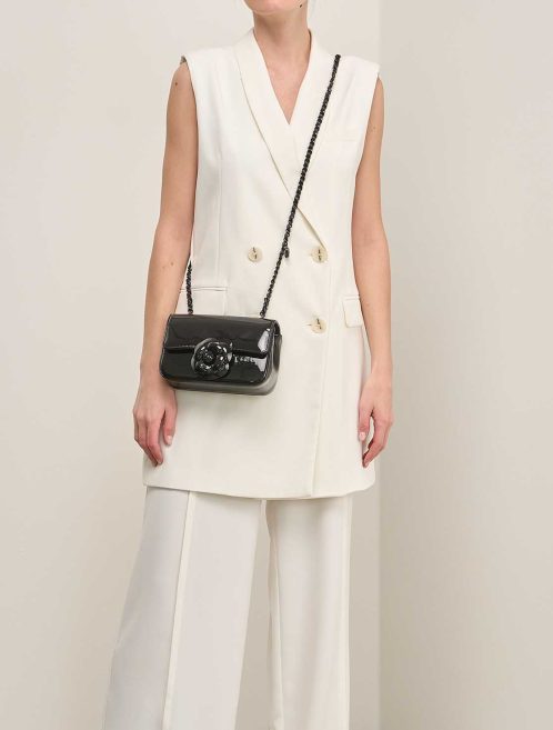Chanel Camellia Flap Bag Small Patent Black on Model | Sell your designer bag