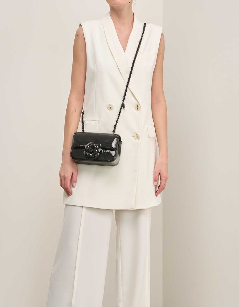 Chanel Camellia Flap Bag Small Patent Black on Model | Sell your designer bag