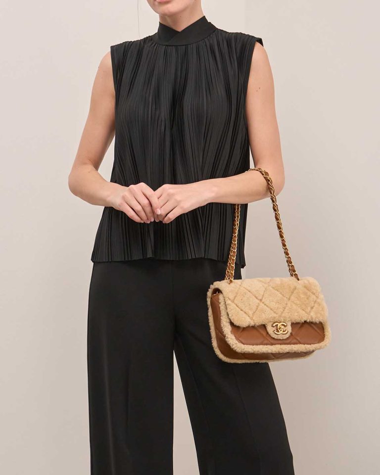 Chanel Timeless Handle Medium Lamb / Shearling Cognac / Beige on Model | Sell your designer bag