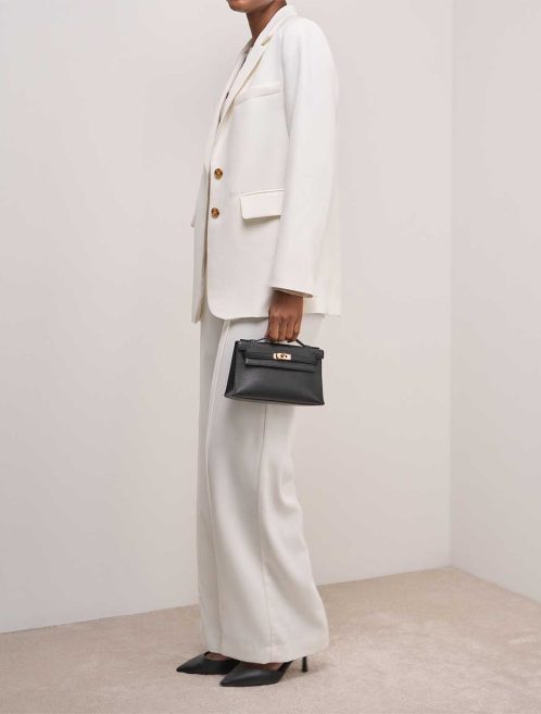 Hermès Kelly Pochette Swift Black on Model | Sell your designer bag