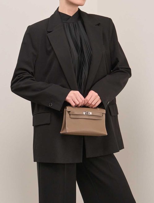 Hermès Kelly Pochette Swift Étoupe on Model | Sell your designer bag