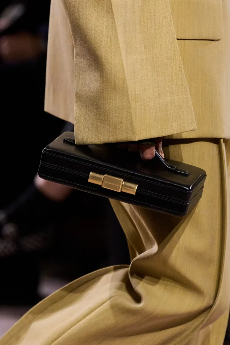 Black Victoria Beckham vanity case with structured gold clasp