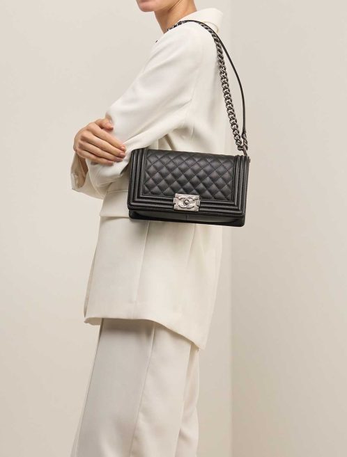 Chanel Boy Old Medium Caviar Black on Model | Sell your designer bag