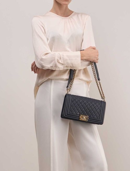Chanel Boy Old Medium Caviar Dark Blue on Model | Sell your designer bag