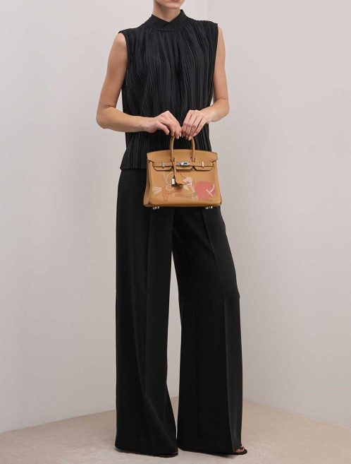 Hermès Birkin In and Out 25 Swift Biscuit on Model | Sell your designer bag
