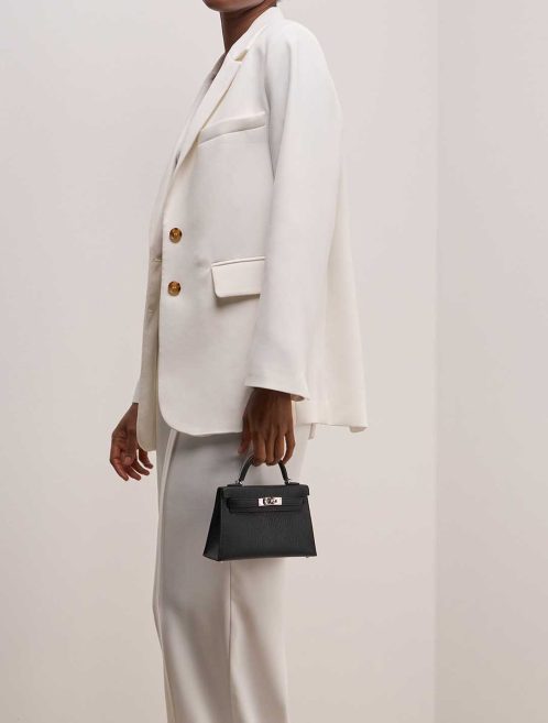 Hermès Kelly Mini Chèvre Mysore Black / Alezan on Model | Sell your designer bag